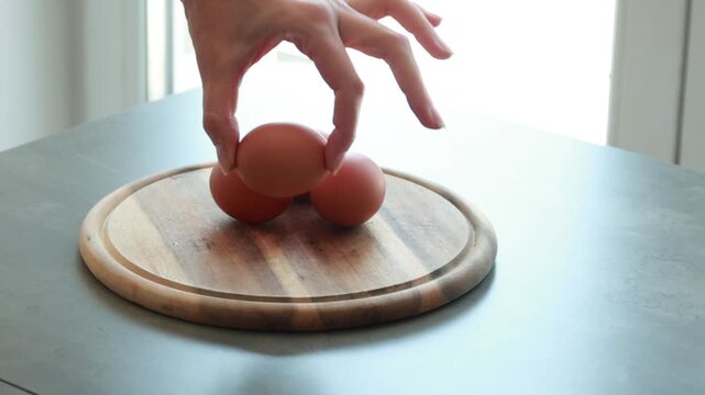 Female Hand Holding Whole Boiled Egg for Healthy Protein Breakfast