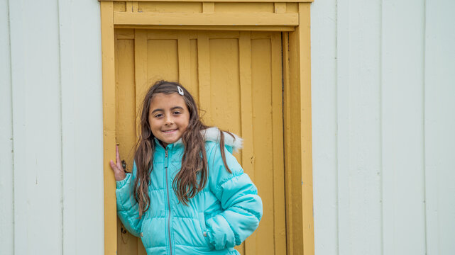 Cute girl walking through Glaumbaer Iceland village admiring traditional homes and scenic landscape
