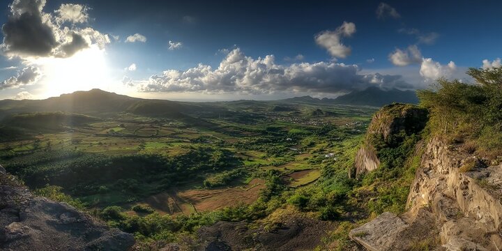Panoramic view of a lush green valley under a bright sky.