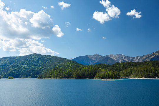 Travel landscape of Eibsee lake and  mountain peak in Alps in Bavaria,  Germany, scenic summer nature panorama with forest und mountains. Alpine landscape