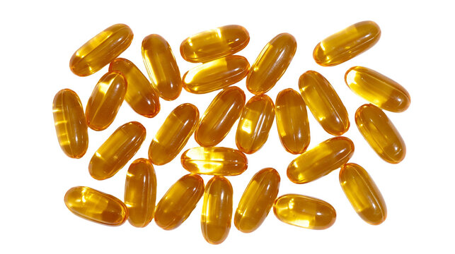 Amber oval softgel capsules scattered