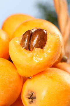 Fresh Ripe Loquat Fruits Cut Open Showing Juicy Orange Flesh and Seeds - Tropical Stone Fruit