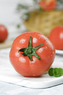 Fresh Red Tomato with Water Drops on White Cutting Board - Healthy Organic Vegetable