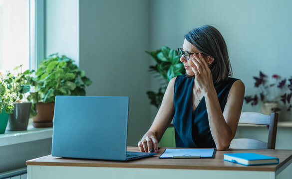 Thoughtful businesswoman working from home at her desk