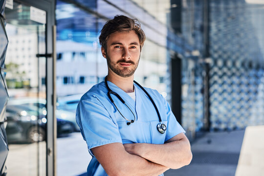 Confident doctor with stethoscope standing outdoor at clinic