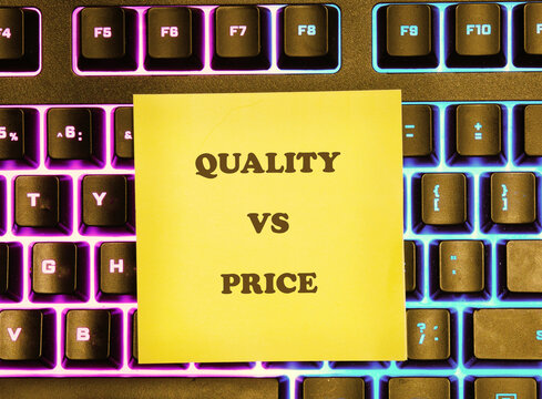 A sticky note on a computer keyboard shows the words quality and price. This image represents the common debate consumers face when making purchases