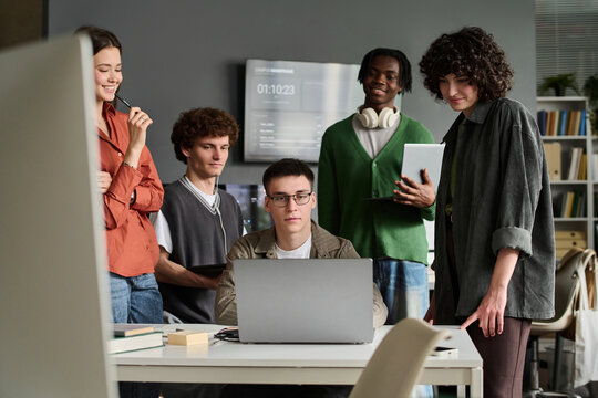 Diverse student group studies online with a laptop indoors