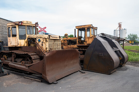 View of old yellow bulldozers and heavy construction machinery parked at the Port of Ventspils, Ventspils, Ventspils Municipalit, Latvia.