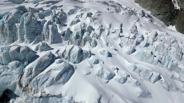 Aerial view of the rugged ice formations and deep crevasses of the glacier near the Schonbielhutte SAC in Zermatt, Wallis, Switzerland.