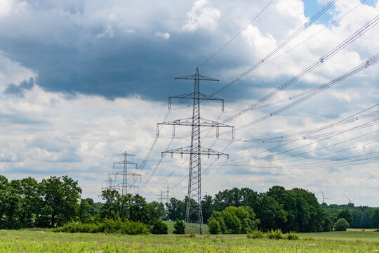 Green nature energy. Landscape of electric voltage station. High voltage. Electricity pylon structure. Nature summer environment. Electricity tower. Electricity power lines in nature landscape
