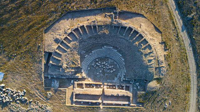 Aerial view of Savatra Ancient City ruins featuring a semicircular theater and surrounding archaeological remains in the arid landscape Karatay, Konya, Turkiye.