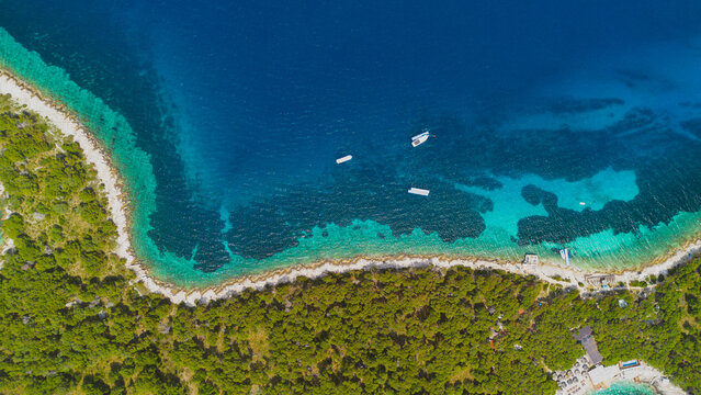 Aerial view of Pakleni Islands with turquoise water, rocky coastline, and dense green vegetation in Split-Dalmatia County, Croatia.