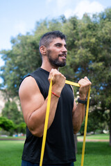 Fototapeta premium Man doing bicep curl with resistance band