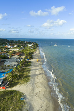 Aerial view of Seixas Beach with white sand, turquoise water, palm trees, and coastal buildings in Joao Pessoa, Paraiba, Brazil.