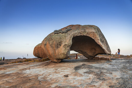 View of the iconic Lajedo de Pai Mateus rock formation with its unique cavernous shape, set against a clear blue sky in the arid landscape of Cabaceiras, Paraiba, Brazil.