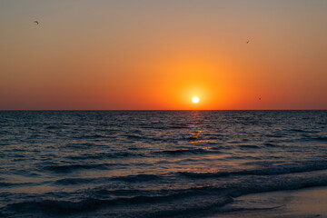Fototapeta premium Sunrise seascape. Romantic summer vacation seascape. Sea sunset horizon. Sunset cloudy sky. Seascape at summer vacation. Dramatic sky. Skyscape with sea horizon. Horizon sunrise sea with sun