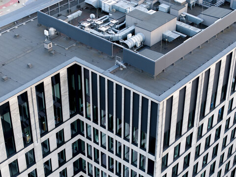 Aerial view of a modern office building rooftop featuring industrial HVAC systems and ventilation units in Krakow, Lesser Poland Voivode, Poland.