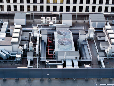 Aerial view of HVAC systems and industrial cooling units installed on the rooftop of a modern office building in Krakow, Lesser Poland Voivode, Poland.