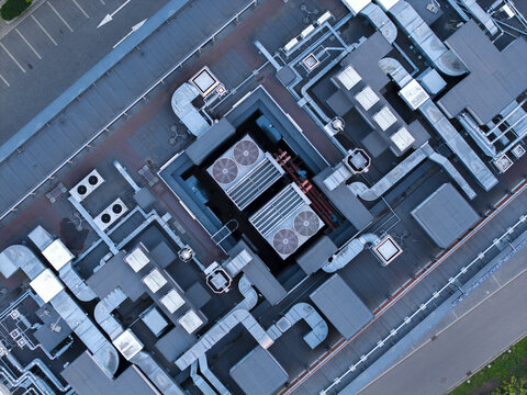 Aerial view of industrial HVAC systems and ventilation ducts on a flat office building rooftop in Krakow, Lesser Poland Voivode, Poland.
