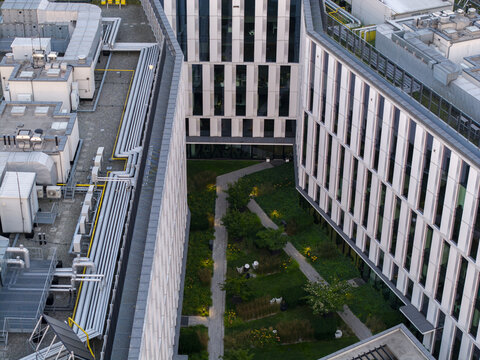 Aerial view of modern office buildings with rooftop HVAC systems and a central landscaped courtyard in Krakow, Lesser Poland Voivode, Poland.