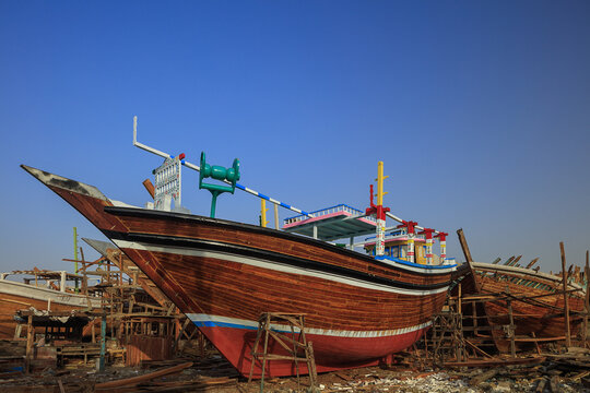 View of a traditional wooden dhow boat under construction in a shipyard in Karachi, Sindh, Pakistan.