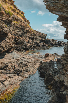 View of the rugged rocky cliffs and clear water at Cala des Murtar, Illes Balears, Islas Baleares, Spain.