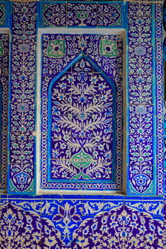 View of intricate blue and white floral kashi tile work decorating the walls of the historic shrine in Bhit Shah, Sindh, Pakistan.