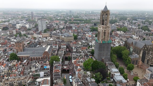 Aerial view of the historic Dom Tower and surrounding medieval city center of Utrecht with canals, rooftops, and dense urban architecture in Utrecht, Utrecht, Netherlands.