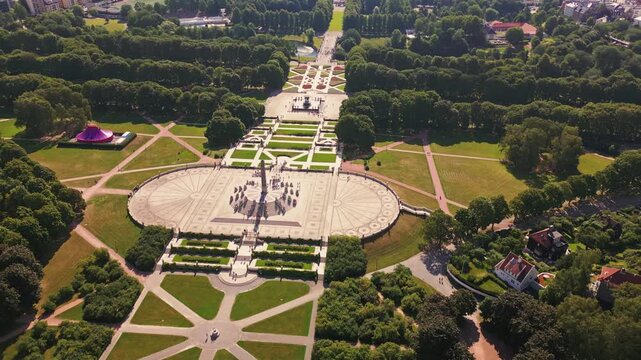 Aerial view of The Vigeland Park with its iconic monolith sculpture and symmetrical pathways surrounded by lush green lawns and trees in Oslo, Oslo, Norway.