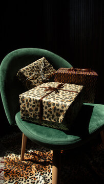 Stylish holiday gifts sit on a green armchair
