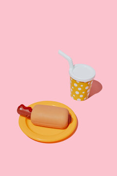 A plastic toy hotdog and a drink cup sit on a pink background