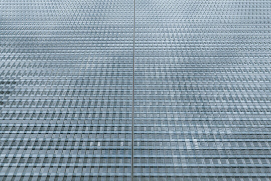 Aerial view of a large-scale commercial greenhouse with a repeating grid pattern of glass panels in Poland.