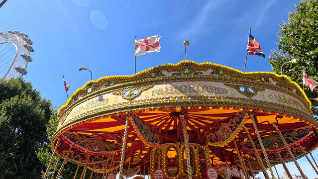 Vintage Carousel and London Eye Under a Clear Blue Sky