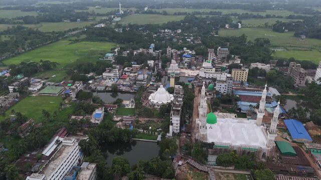Aerial view of Maizbhandar Darbar Sharif complex with white domes and minarets, surrounded by green fields and ponds in Fatikchhari Upazila, Chittagong Division, Bangladesh.