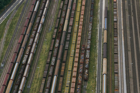 Aerial view of freight trains parked on multiple parallel tracks at the railway yard in Saalfeld, Thuringia, Germany.