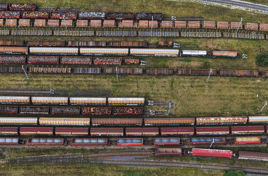 Aerial view of freight train cars parked on multiple parallel tracks in a railway yard in Saalfeld, Thuringia, Germany.