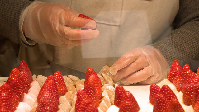 Gloved Hands Preparing Fresh Strawberry Mochi Daifuku at Tsukiji Market