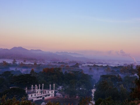 View of a mosque in Nhila, Teknaf, surrounded by misty mountains and lush greenery at sunrise in Cox's Bazar, Chittagong Division, Bangladesh.