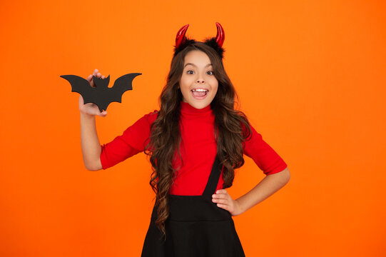All Hallows. Funny party devil. Girl devil with Halloween party outfit. Happy Halloween. Amazed girl ready for Halloween party isolated on orange. Trick or treat. All Hallows party celebration