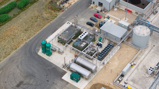 Aerial view of the Moor Bio Energy biomass plant featuring industrial tanks, cooling systems, and processing infrastructure in Grantham, England, United Kingdom.