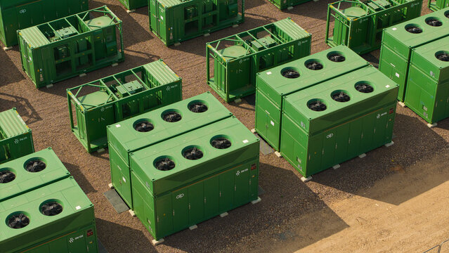 Aerial view of National Grid Hams Hall Battery Energy Storage Systems with rows of green industrial battery containers and cooling fans in Birmingham, England, United Kingdom.