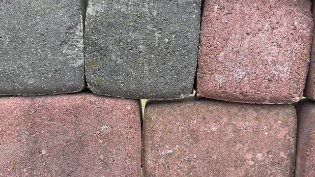 Paving stone samples top view closeup, textured cobble tiles arranged on display stand in hardware store, closeup top down framing