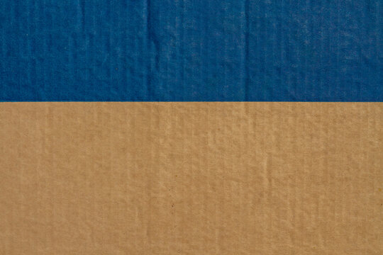 color blue with horizontal composition on brown paperboard. natural corrugated cardboard texture abstract geometric background.