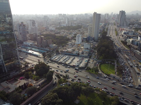 Aerial view of Javier Prado Este avenue with heavy traffic, modern high-rise buildings, and urban greenery in San Isidro, Provincia de Lima, Peru.