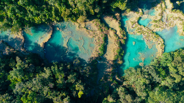 Aerial view of Semuc Champey with its turquoise limestone pools surrounded by lush tropical rainforest in San Agustin Lanquin, Alta Verapaz Department, Guatemala.