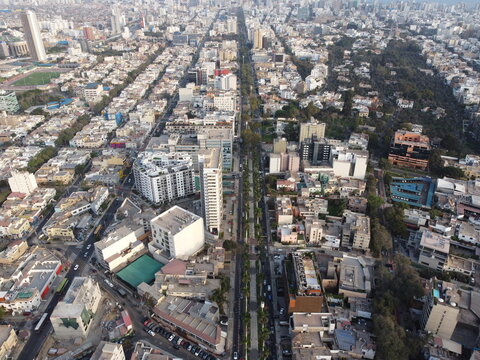 Aerial view of Avenida Arequipa lined with trees and surrounded by dense urban buildings and residential blocks in San Isidro, Lima Province, Peru.