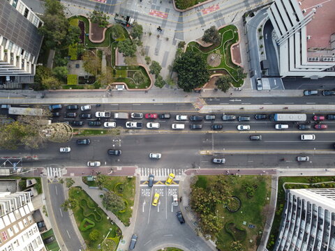 Aerial view of the busy intersection in San Isidro, featuring urban traffic, modern buildings, and landscaped green spaces in San Isidro, Lima Province, Peru.