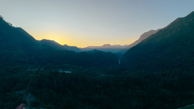 Aerial view of the lush mountainous landscape of Semuc Champey at sunrise with dense forest and a deep valley, San Agustin Lanquin, Alta Verapaz Department, Guatemala.
