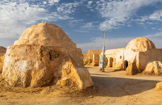 View of the iconic Star Wars Mos Espa film set featuring dome-shaped desert structures under a clear blue sky in Nefta, Tozeur Governorate, Tunisia.