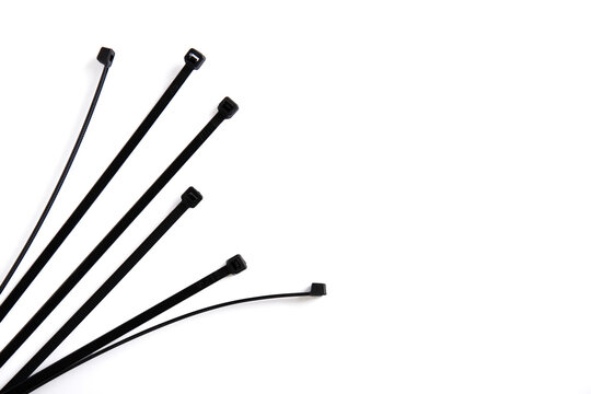 Black cable ties on a white background with extra space